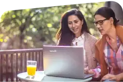 Friends using a laptop outdoors