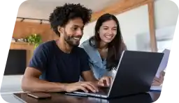 Two people surfing the web on a laptop