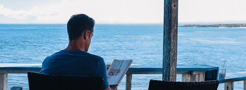 man reading on vacation