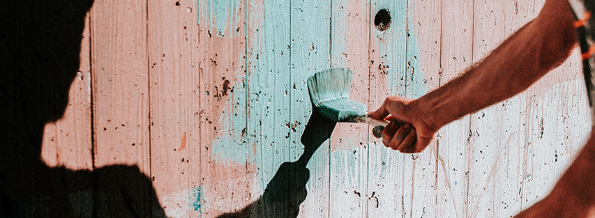 volunteer painting fence image