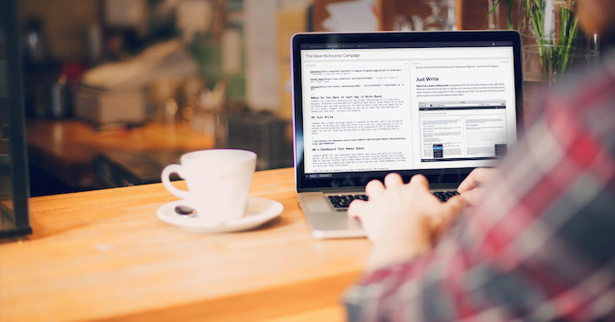 man on computer in coffee shop
