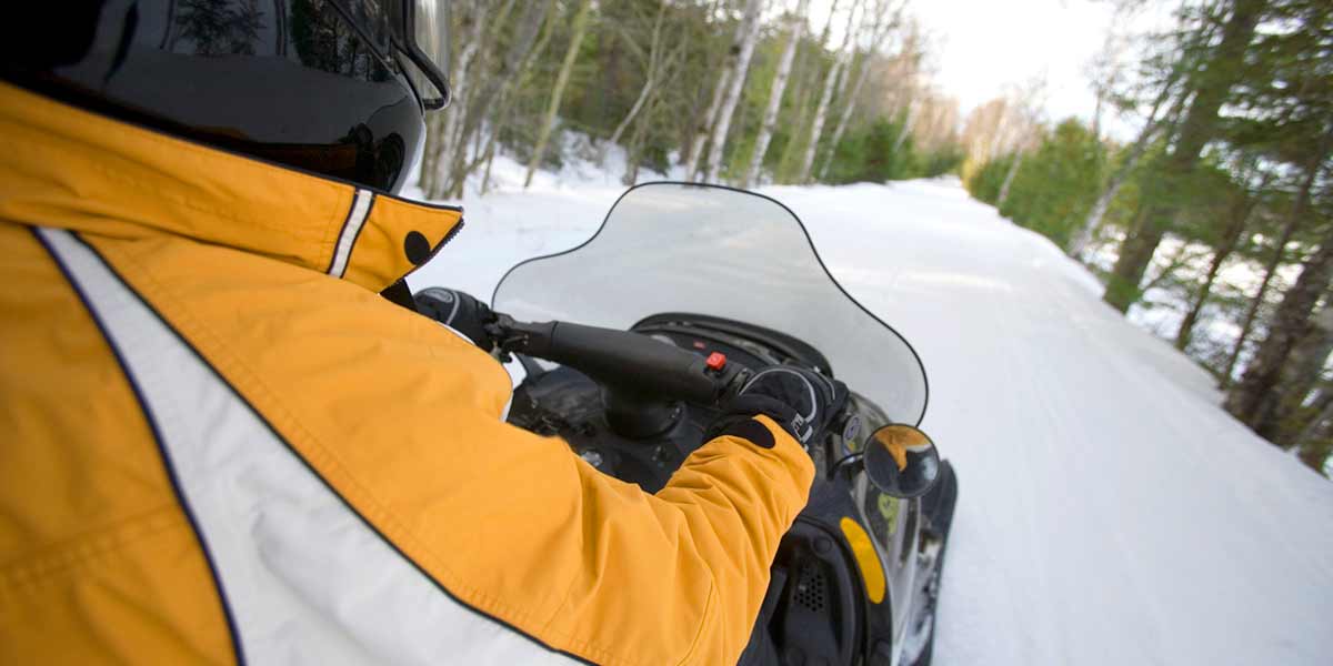 Image of person riding snow mobile