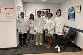Dhruv Pradman and team in lab coats