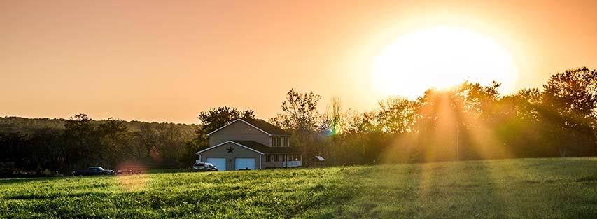 Sunset over a rural home, where Hughesnet satellite internet provides reliable connectivity for remote living.