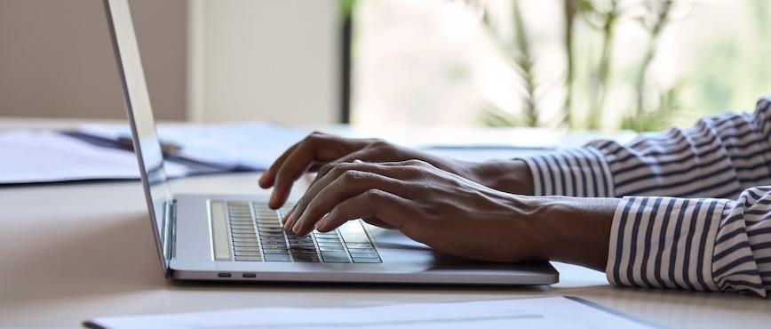 woman typing on laptop