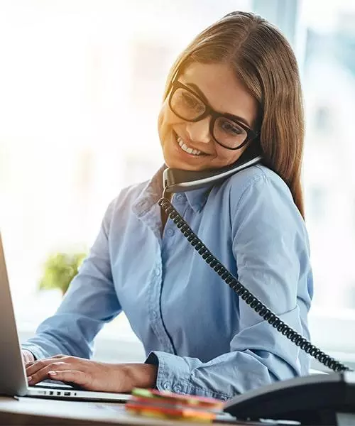 woman working from home while on the phone