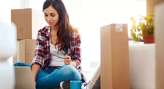 woman surrounded by moving boxes