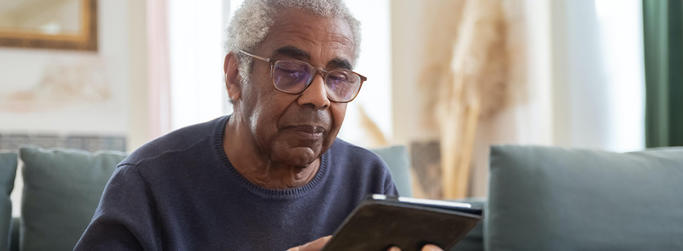 man reading on tablet