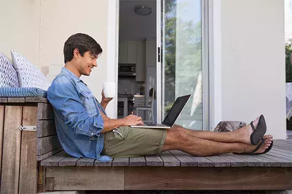 man on porch drinking coffee