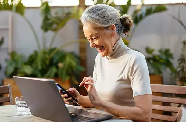 woman enjoying hughesnet on her porch