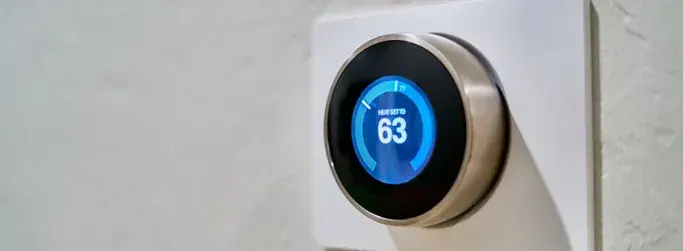 Smart thermostat displaying the temperature, demonstrating an example of the Internet of Things in action.