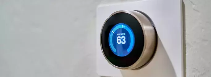 Smart thermostat displaying the temperature, demonstrating an example of the Internet of Things in action.