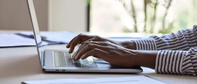 woman typing on laptop