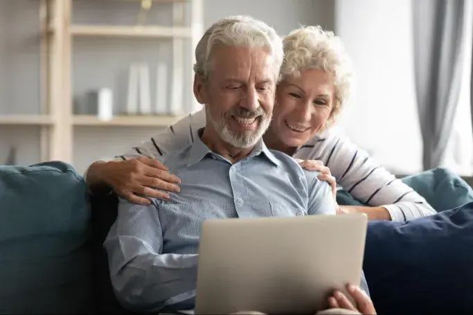 A couple looking at a laptop together 