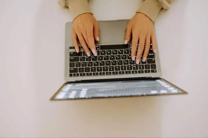 Woman typing on a keyboard 