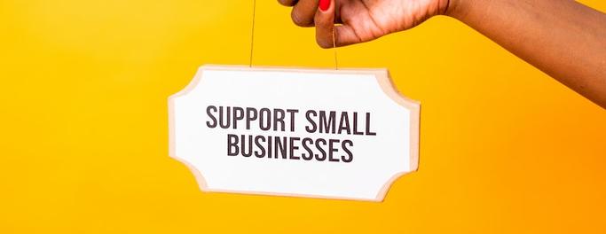 sign that says support small business