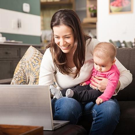 Image of woman with baby benefiting from more data from HughesNet Gen5